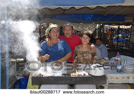 Family at the shashlik grill at the bazaar Khiva Uzbekistan View Large Photo Image Stock Photo - Family at the shashlik grill at the bazaar Khiva Uzbekistan. Fotosearch