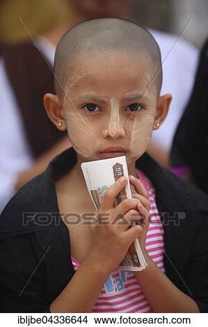 Picture - Girl gives money gift, Bigboon pilgrims' procession, day of meditation of the Dhammakaya Foundation, Dawei, Tanintharyi Region, Myanmar, Asia *** IMPORTANT: Image may not be used in a negative context with the Dhammakaya temple ***. Fotosearch
