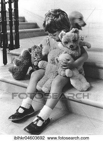 Girl plays with a baby predator and stuffed animals, England, Great Britain View Large Photo Image Stock Image - Girl plays with a baby predator and stuffed animals, England, Great Britain. Fotosearch