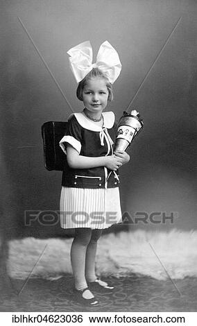 Stock Photograph - Girl with school bag and big hair bow ca. 1926, exact place unknown, Germany, Europe. Fotosearch