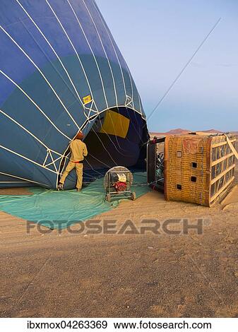 Heissluftballon wird mit Luft gefullt, Kulala Wilderness Reserve, Namib-Wuste, Tsarisberge, Region Hardap, Namibia, Afrika View Large Photo Image Stock Photo - Heissluftballon wird mit Luft gefullt, Kulala Wilderness Reserve, Namib-Wuste, Tsarisberge, Region Hardap, Namibia, Afrika. Fotosearch