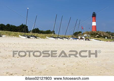 Stock Image - Hoernum beach, catamarans and a lighthouse on the horizon, Hoernum, Sylt, North Frisia, Schleswig-Holstein, Germany, Europe. Fotosearch