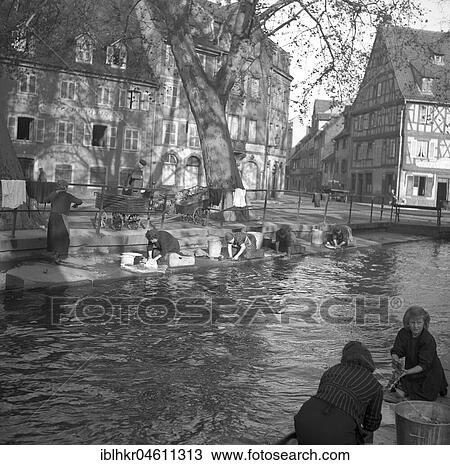 Housewives do their laundry on the banks of a river, ca. 1955, Freiburg, Germany, Europe View Large Photo Image Stock Image - Housewives do their laundry on the banks of a river, ca. 1955, Freiburg, Germany, Europe. Fotosearch