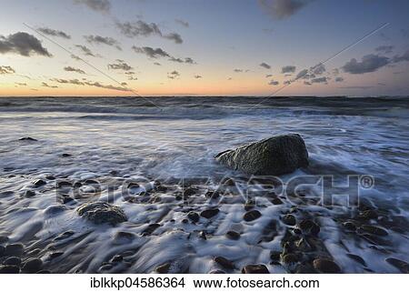 Large stone on the beach, washed by water in the surf, Baltic Sea coast near Bakenberg, Rügen, Mecklenburg-Western Pomerania, Germany, Europe View Large Photo Image Picture - Large stone on the beach, washed by water in the surf, Baltic Sea coast near Bakenberg, Rügen, Mecklenburg-Western Pomerania, Germany, Europe. Fotosearch