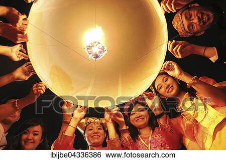 Stock Photograph - Light of Peace Festival on Visakha Puja Day, Kong Ming lanterns, young people with sky lanterns, lantern, Light of Peace Festival of the Dhammakaya Foundation, Ancol Beach, Jakarta, Indonesia, Asia *** IMPORTANT: Image may not be used in a negative.... Fotosearch