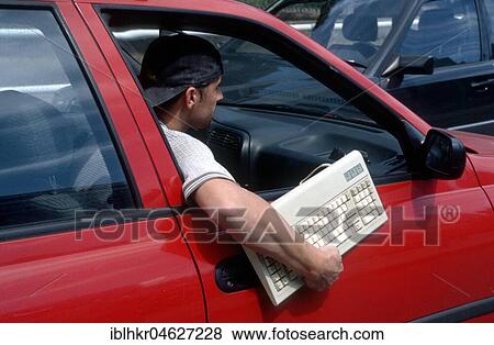 Man holding keyboard out of the car window, Berlin, Germany, Europe View Large Photo Image Stock Photo - Man holding keyboard out of the car window, Berlin, Germany, Europe. Fotosearch