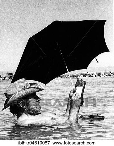 Man with parasol in water, Mexico City, Mexico, Central America View Large Photo Image Stock Photo - Man with parasol in water, Mexico City, Mexico, Central America. Fotosearch