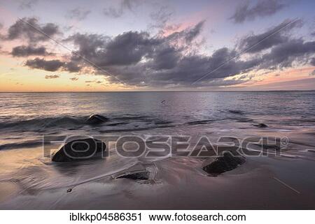 Morning atmosphere at the sea, stones in the surf at the Baltic Sea coast near Sassnitz, Rügen, Mecklenburg-Western Pomerania, Germany, Europe View Large Photo Image Stock Image - Morning atmosphere at the sea, stones in the surf at the Baltic Sea coast near Sassnitz, Rügen, Mecklenburg-Western Pomerania, Germany, Europe. Fotosearch