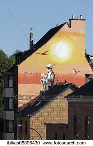 Mural See-Watch by streetart artist Klaus Klinger, boy fishing paper boats, theme refugee rescue in the Mediterranean, Düsseldorf, North Rhine-Westphalia, Germany, Europe View Large Photo Image Stock Image - Mural See-Watch by streetart artist Klaus Klinger, boy fishing paper boats, theme refugee rescue in the Mediterranean, Düsseldorf, North Rhine-Westphalia, Germany, Europe. Fotosearch