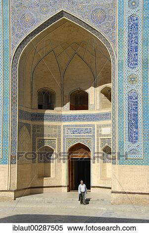 Stock Photography - Muslim believer in the entrance (iwan) of Mosque Kalon Bukhara Uzbekistan. Fotosearch