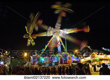 Oktoberfest, Wiesn, amusement rides, giant rotating pendulum at night, different rotational positions, Munich, Bavaria, Germany, Europe View Large Photo Image Stock Image - Oktoberfest, Wiesn, amusement rides, giant rotating pendulum at night, different rotational positions, Munich, Bavaria, Germany, Europe. Fotosearch