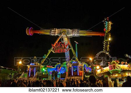 Stock Image - Oktoberfest, Wiesn, amusement rides, giant rotating pendulum at night, Munich, Bavaria, Germany, Europe. Fotosearch