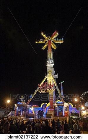 Stock Image - Oktoberfest, Wiesn, amusement rides, giant rotating pendulum at night, Munich, Bavaria, Germany, Europe. Fotosearch
