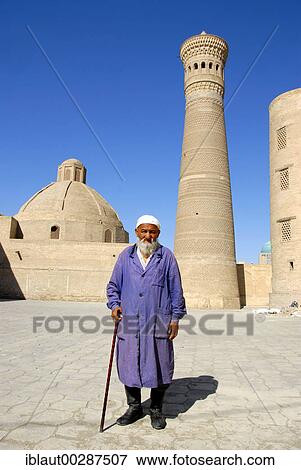 Old Muslim believer with beard in front of Minaret Kalon Bukhara Uzbekistan View Large Photo Image Stock Photo - Old Muslim believer with beard in front of Minaret Kalon Bukhara Uzbekistan. Fotosearch