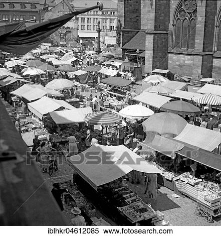 Overview of the market stalls at the cathedral, Freiburger Münstermarkt, approx. 1945 to 1955, Freiburg, Germany, Europe View Large Photo Image Stock Photography - Overview of the market stalls at the cathedral, Freiburger Münstermarkt, approx. 1945 to 1955, Freiburg, Germany, Europe. Fotosearch
