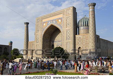 Stock Image - People dancing at Madrasah Sherdar Registan Samarkand Uzbekistan. Fotosearch