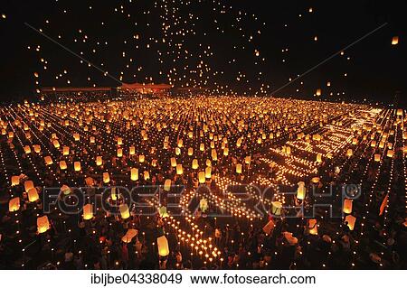 Stock Photo - People letting sky lanterns rise, World Peace Festival of the Dhammakaya Foundation, Dawei, Tanintharyi Region, Myanmar, Asia *** IMPORTANT: Image may not be used in a negative context with the Dhammakaya temple ***. Fotosearch