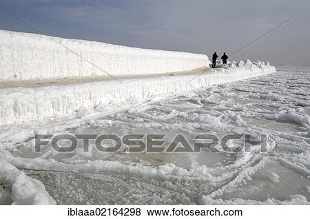 Stock Photo - People walking on icy pier, frozen Black Sea, a rare phenomenon, last time it occured in 1977, Odessa, Ukraine, Eastern Europe, Europe. Fotosearch