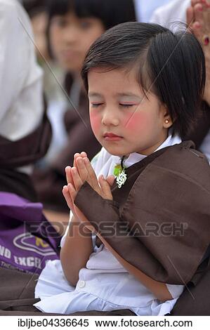 Praying girl at the Bigboon pilgrims' procession, day of meditation of the Dhammakaya Foundation, Dawei, Tanintharyi Region, Myanmar, Asia *** IMPORTANT: Image may not be used in a negative context with the Dhammakaya temple *** View Large Photo Image Stock Photography - Praying girl at the Bigboon pilgrims' procession, day of meditation of the Dhammakaya Foundation, Dawei, Tanintharyi Region, Myanmar, Asia *** IMPORTANT: Image may not be used in a negative context with the Dhammakaya temple ***. Fotosearch