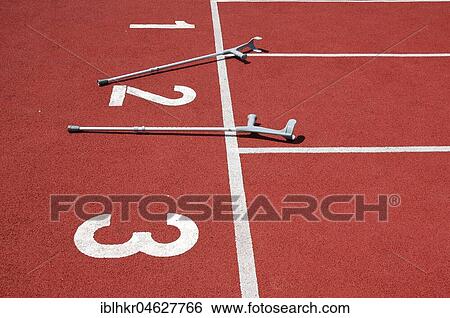 Stock Photograph - Recovery, miracle cure, crutches on the sports field, Germany, Europe. Fotosearch