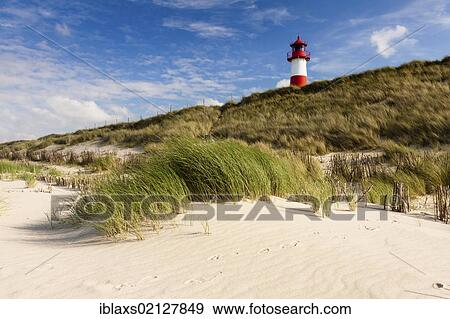Red and white striped lighthouse of List Ost amidst the sand dunes, seen from the beach, List, Sylt, North Frisia, Schleswig-Holstein, Germany, Europe View Large Photo Image Stock Photo - Red and white striped lighthouse of List Ost amidst the sand dunes, seen from the beach, List, Sylt, North Frisia, Schleswig-Holstein, Germany, Europe. Fotosearch