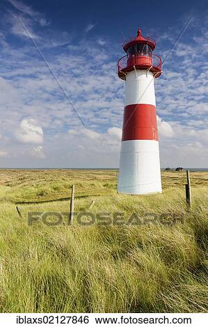 Stock Photograph - Red and white striped lighthouse of List Ost on the Sylt peninsula of Ellenbogen, List, Sylt, North Frisia, Schleswig-Holstein, Germany, Europe. Fotosearch