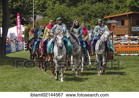 Riders of the Royal Cavalry of Oman wearing brightly-coloured uniforms during a presentation at Pferd International Muenchen, the International Horse Show in Munich, Bavaria, Germany, Europe View Large Photo Image Stock Photo - Riders of the Royal Cavalry of Oman wearing brightly-coloured uniforms during a presentation at Pferd International Muenchen, the International Horse Show in Munich, Bavaria, Germany, Europe. Fotosearch
