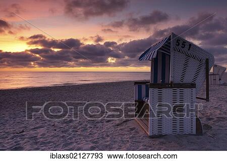 Roofed wicker beach chair on the beach at sunset, Hoernum, Sylt, North Frisia, Schleswig-Holstein, Germany, Europe View Large Photo Image Stock Image - Roofed wicker beach chair on the beach at sunset, Hoernum, Sylt, North Frisia, Schleswig-Holstein, Germany, Europe. Fotosearch