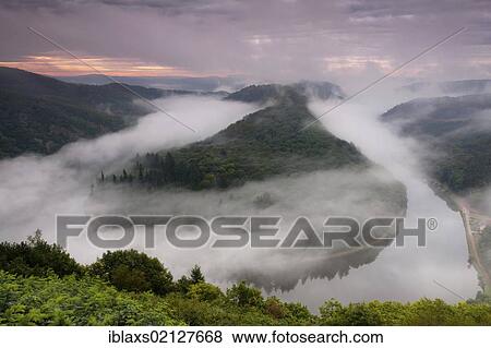 Saar Loop at sunrise with a light mist over the course of the river, Saar, Orscholz, Saarland, Germany, Europe View Large Photo Image Stock Photo - Saar Loop at sunrise with a light mist over the course of the river, Saar, Orscholz, Saarland, Germany, Europe. Fotosearch