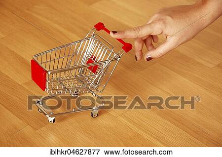 Stock Photo - Saving, Miniature Shopping Cart, Germany, Europe. Fotosearch