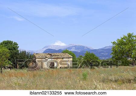 Stone hut in the interior of the island, the Tramuntana mountains at back, Majorca, Balearic Islands, Spain, Europe View Large Photo Image Stock Photography - Stone hut in the interior of the island, the Tramuntana mountains at back, Majorca, Balearic Islands, Spain, Europe. Fotosearch