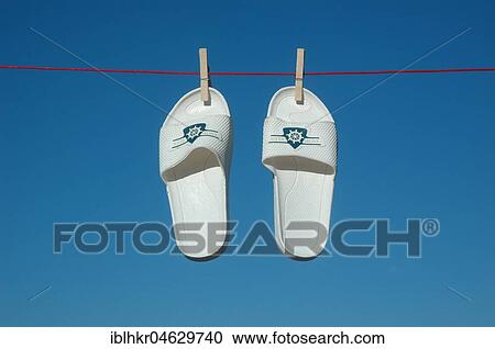 Stock Image - Swim slippers on a clothesline, Germany, Europe. Fotosearch