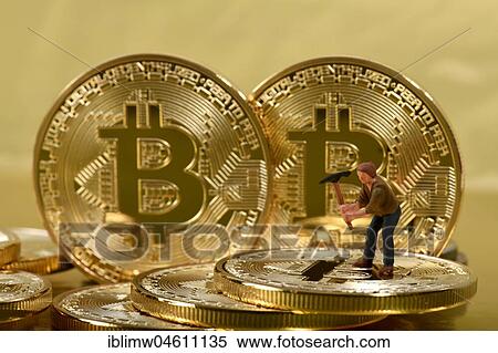 Stock Photography - Symbol image, Gold digger, digital currency, gold coin Bitcoin. Fotosearch