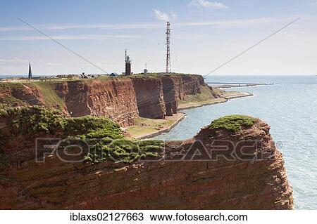 The prominent steep red sandstone cliffs of Heligoland with its lighthouse and a radio tower, Helgoland, Schleswig-Holstein, Germany, Europe View Large Photo Image Stock Image - The prominent steep red sandstone cliffs of Heligoland with its lighthouse and a radio tower, Helgoland, Schleswig-Holstein, Germany, Europe. Fotosearch