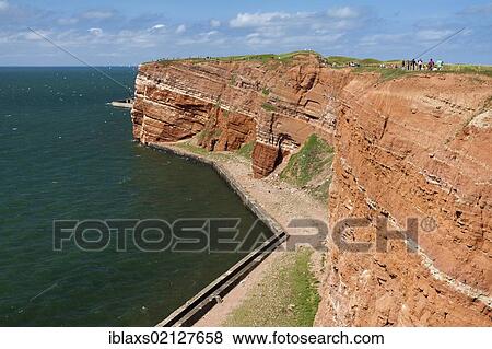 The prominent steep red sandstone cliffs of Heligoland, Helgoland, Schleswig-Holstein, Germany, Europe View Large Photo Image Stock Photo - The prominent steep red sandstone cliffs of Heligoland, Helgoland, Schleswig-Holstein, Germany, Europe. Fotosearch