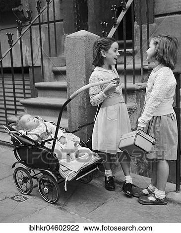 Stock Image - Two girls with baby, Fifties, England, Great Britain. Fotosearch