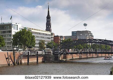 Stock Photo - View from the Hamburg Speicherstadt historic warehouse district over the inland port and the tower of St. Catherine's Church, Hamburg, Germany, Europe. Fotosearch