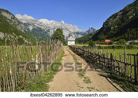 Weg im Tal zwischen Holzzaun zu Kirche, Thethi Tal, Theth, Thethi Nationalpark, Albanische Alpen, Balkan, Albanien, Europa View Large Photo Image Stock Photography - Weg im Tal zwischen Holzzaun zu Kirche, Thethi Tal, Theth, Thethi Nationalpark, Albanische Alpen, Balkan, Albanien, Europa. Fotosearch