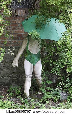 Stock Photo - Woman in a bathing suit with umbrella, figure in the sculpture garden of the artist Jochen Bach, Plinzmühle, Plinz, Großkröbitz, Milda, Thuringia, Germany, Europe. Fotosearch