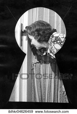 Stock Photo - Woman looking through a keyhole, ca. 1980s, East Berlin, GDR, Germany, Europe. Fotosearch