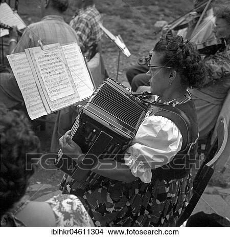 Woman plays accordion after notes, accordion player, ca. 1955, environment of Freiburg, Germany, Europe View Large Photo Image Picture - Woman plays accordion after notes, accordion player, ca. 1955, environment of Freiburg, Germany, Europe. Fotosearch