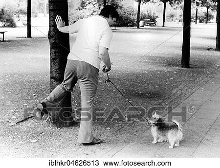 Woman showing a dog how to pee, ca. 1980s, East Berlin, GDR, Germany, Europe View Large Photo Image Stock Image - Woman showing a dog how to pee, ca. 1980s, East Berlin, GDR, Germany, Europe. Fotosearch
