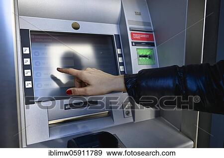 Woman typing on the touch screen of an ATM of a savings bank, Waiblingen, Baden-Württemberg, Germany, Europe View Large Photo Image Stock Photo - Woman typing on the touch screen of an ATM of a savings bank, Waiblingen, Baden-Württemberg, Germany, Europe. Fotosearch