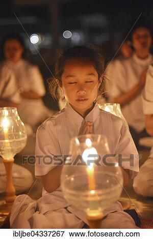 Young girl praying, candlelight, lights, Wat Phra Dhammakaya temple, Bangkok, Thailand, Asia *** IMPORTANT: The images may be used only in the positive sense of the Dhammakaya temple *** View Large Photo Image Stock Photo - Young girl praying, candlelight, lights, Wat Phra Dhammakaya temple, Bangkok, Thailand, Asia *** IMPORTANT: The images may be used only in the positive sense of the Dhammakaya temple ***. Fotosearch