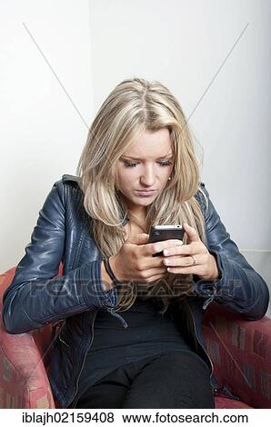 Young woman, 18-25 years, using an Apple iPhone View Large Photo Image Stock Photo - Young woman, 18-25 years, using an Apple iPhone. Fotosearch