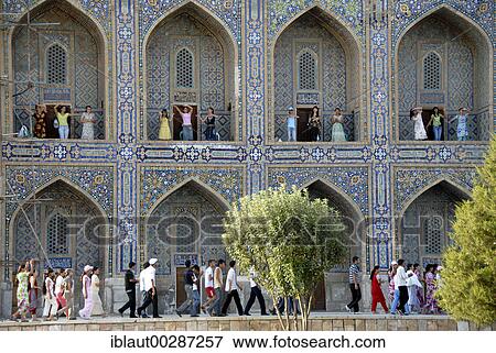 Stock Photo - Young women dancing in arches of Madrasah Tilla-kari Registan Samarkand Uzbekistan. Fotosearch