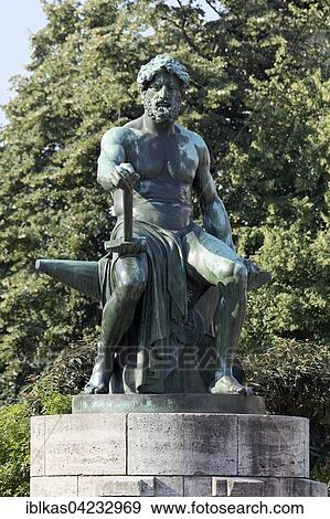Stock Photo - Bronze sculpture, Vulcan sitting on anvil, by Friedrich Coubillier, Industriebrunnen 1912, Dusseldorf, North Rhine-Westphalia, Germany, Europe. Fotosearch