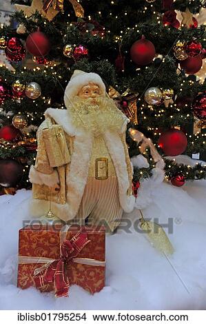 Christmas decoration, Santa Claus with gifts in front of a Christmas tree View Large Photo Image Picture - Christmas decoration, Santa Claus with gifts in front of a Christmas tree. Fotosearch