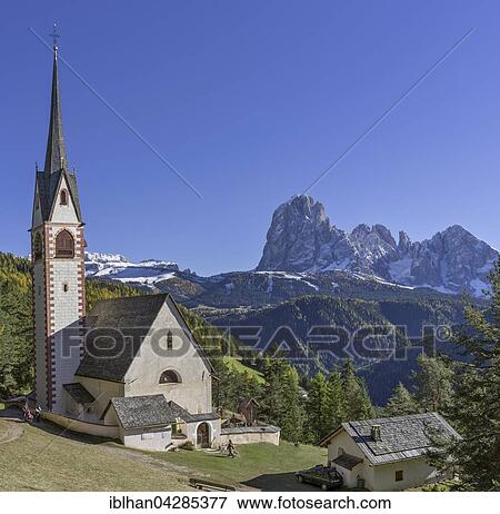 Stock Photo - Church of San Giacomo with Sassolungo and Sasso Piatto, St. Ulrich, Val Gardena, Ortisei, Trentino-Alto Adige, South Tyroll, Italy, Europe. Fotosearch