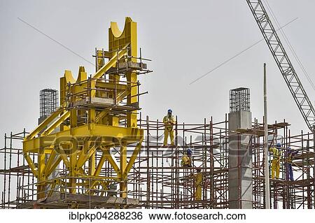 Stock Photograph - Construction workers at construction site of Khalifa International Stadium, Doha, Qatar, Asia. Fotosearch